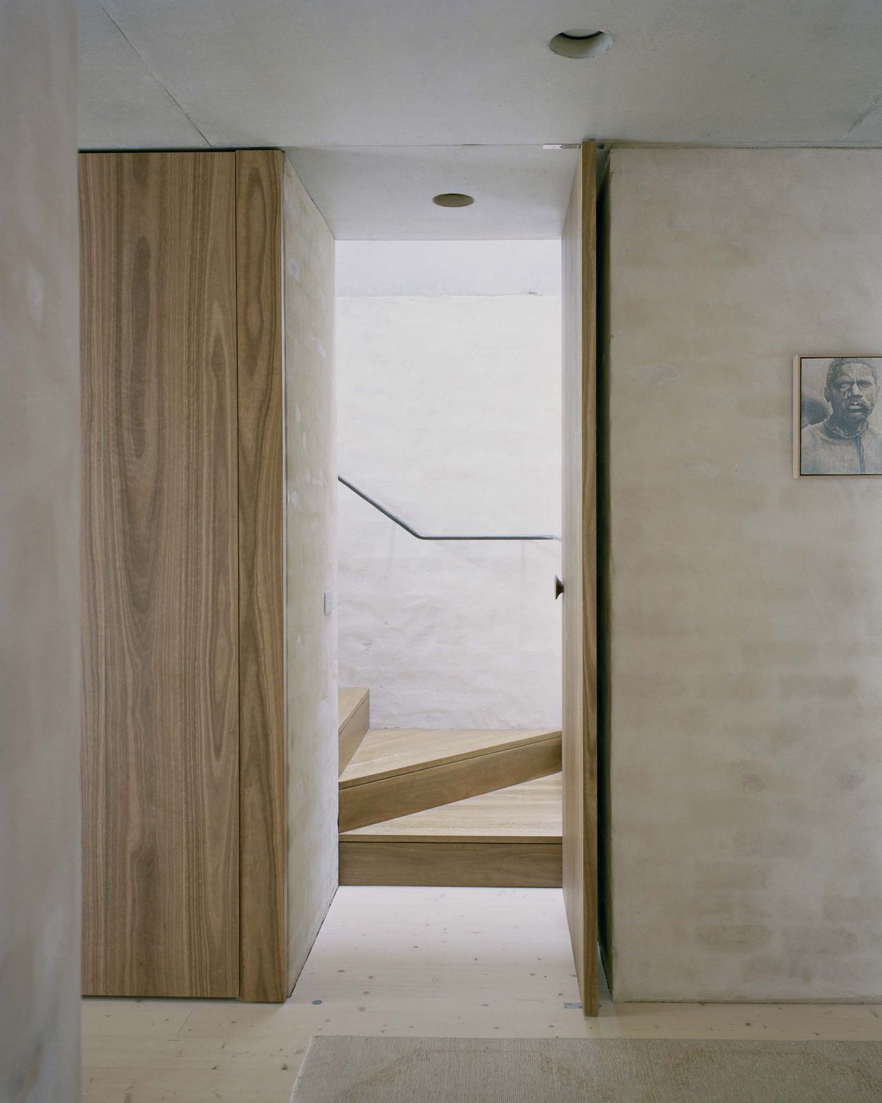 Mary Street House bedroom entry with timber-lined doors and pale plaster walls