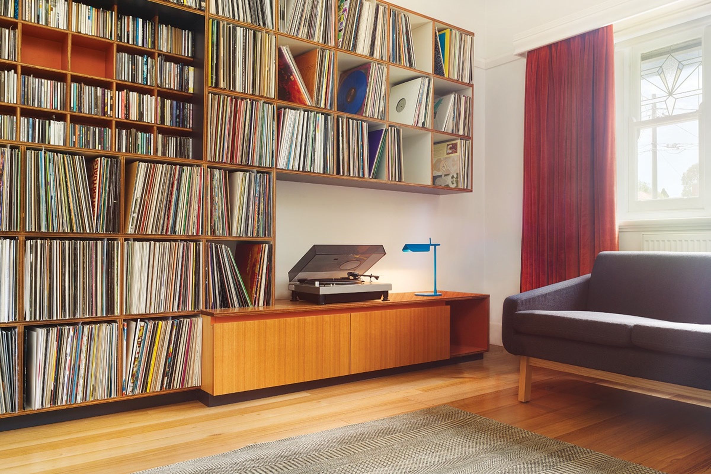 Preston Residence living room with record storage, timber joinery, and sofa